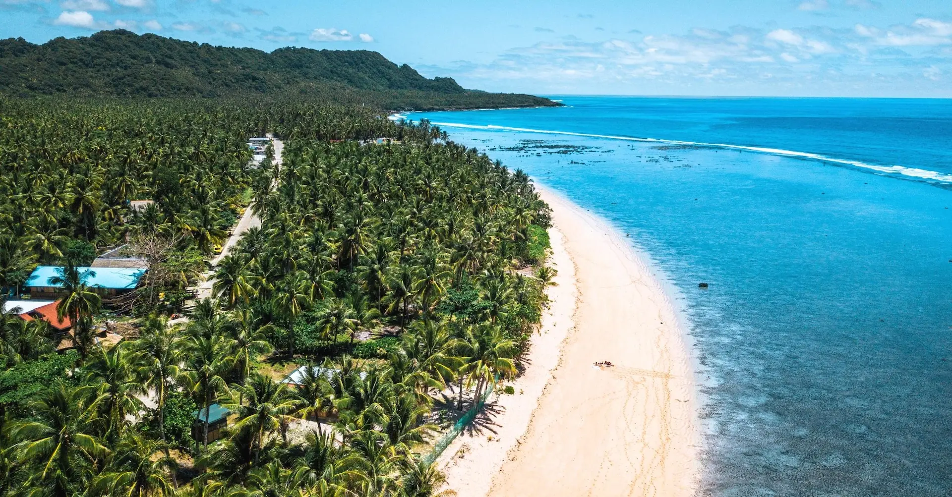 Aerial view of Pacifico Beach with its pristine shoreline in North Siargao