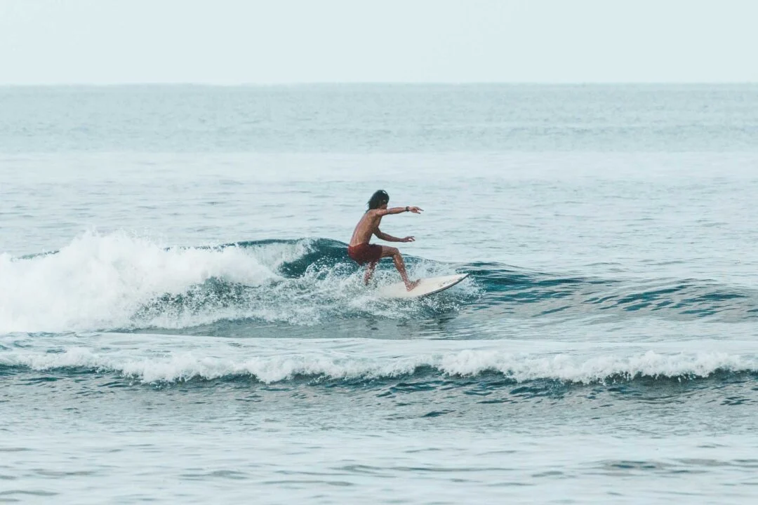 Surfing the Big Wish left-hand reef break at Pacifico Beach, Siargao, Philippines